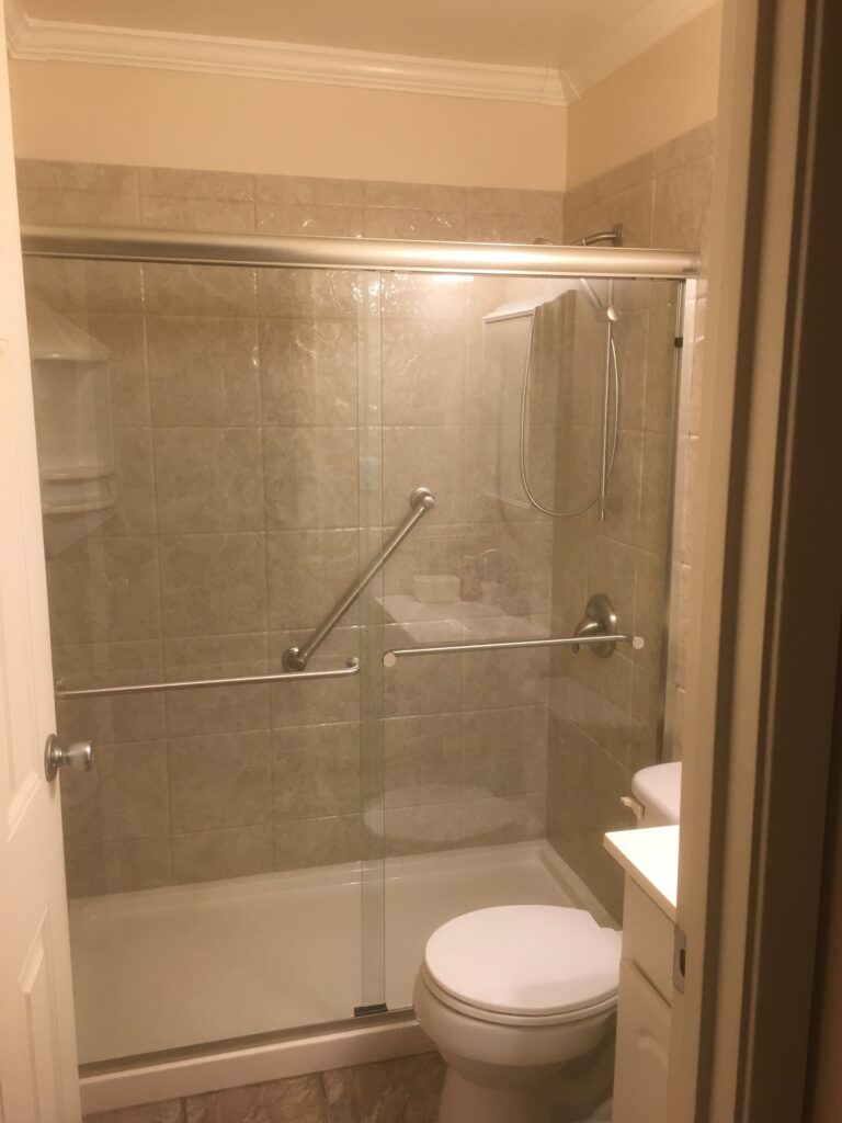 Tub-to-shower conversion with low-threshold base